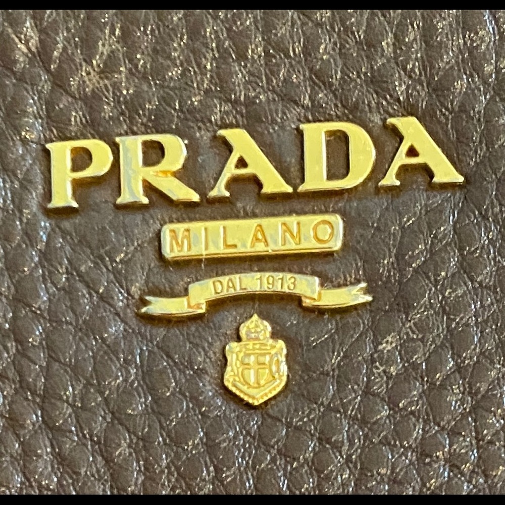 Prada leather handbag with adjustable strap.